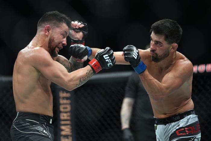 Pedro Munhoz defends against Dominick Cruz during UFC 269 at T-Mobile Arena.